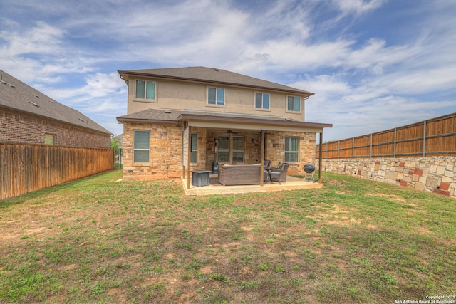 rear view of house with a fenced backyard, a lawn, stucco siding, and a patio area
