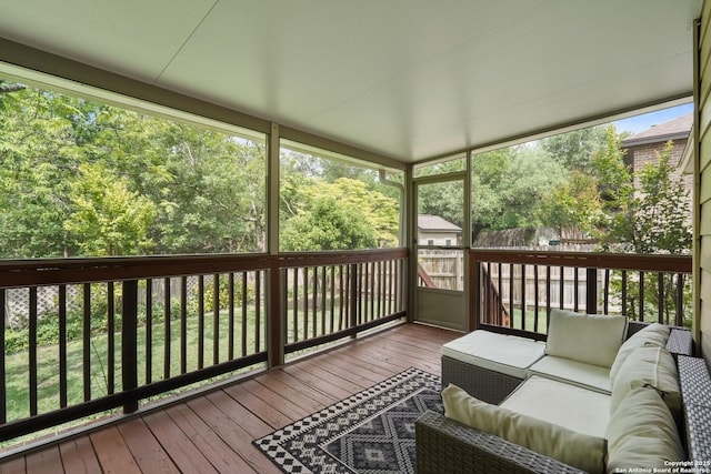 wooden terrace with an outdoor living space