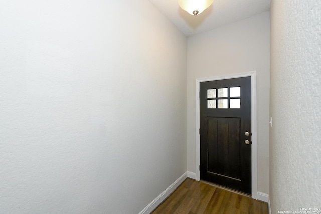 entrance foyer featuring dark wood-style floors and baseboards
