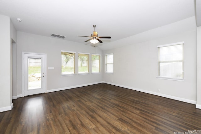 unfurnished room featuring baseboards, ceiling fan, visible vents, and dark wood finished floors
