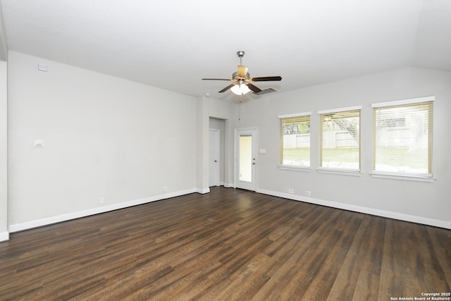 empty room featuring dark wood-style floors, visible vents, ceiling fan, and baseboards