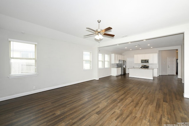 unfurnished living room with recessed lighting, dark wood-type flooring, baseboards, visible vents, and a ceiling fan
