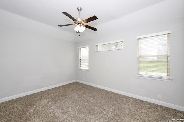 spare room featuring baseboards, carpet floors, and a ceiling fan