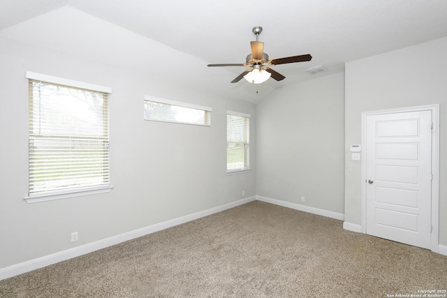 carpeted spare room featuring baseboards, lofted ceiling, ceiling fan, and plenty of natural light
