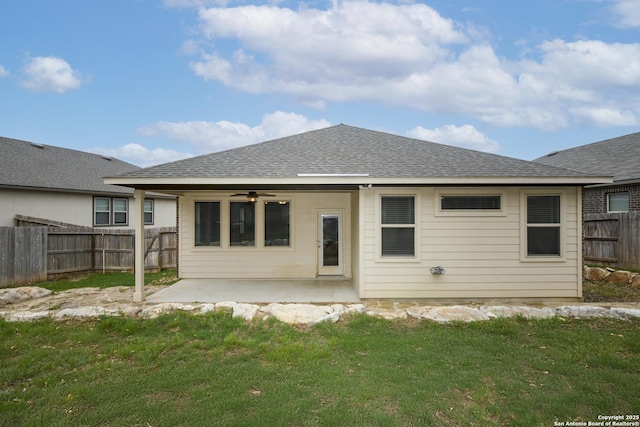 back of house featuring a ceiling fan, a fenced backyard, a shingled roof, a patio, and a yard