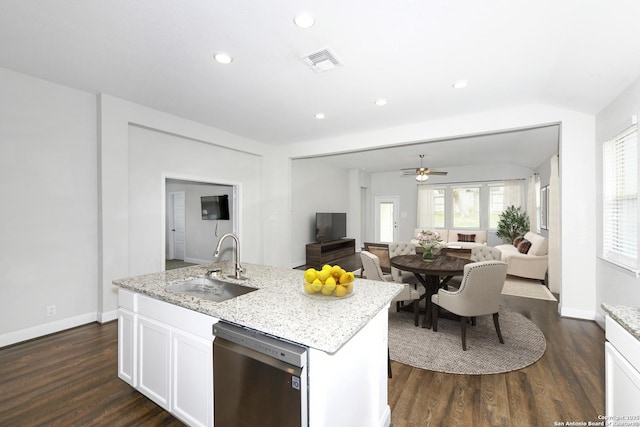 kitchen featuring visible vents, a sink, stainless steel dishwasher, and open floor plan