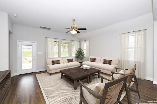 living room with dark wood-style flooring, ceiling fan, visible vents, and lofted ceiling