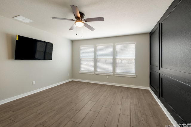 122 Hi Vw, Lakehills, TX 78063 - spare room with dark wood-style floors, ceiling fan, and baseboards