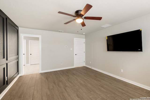 122 Hi Vw, Lakehills, TX 78063 - unfurnished bedroom with wood finished floors, baseboards, and a ceiling fan