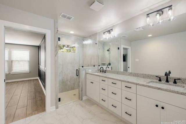 122 Hi Vw, Lakehills, TX 78063 - full bathroom with a marble finish shower, double vanity, baseboards, marble look tile flooring, and recessed lighting
