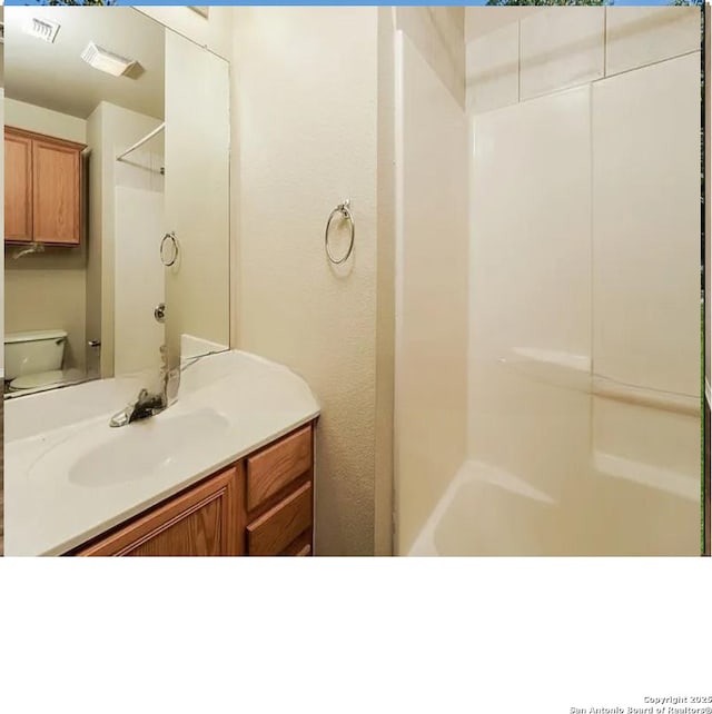 7126 Tourant, San Antonio, TX 78240 - bathroom featuring toilet, walk in shower, vanity, and visible vents