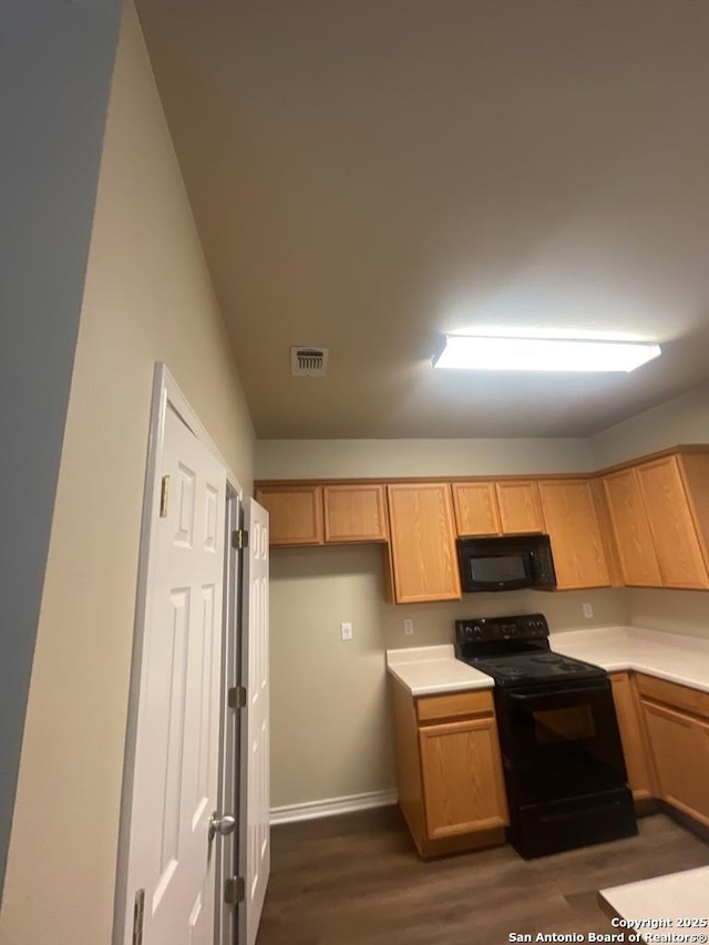 7126 Tourant, San Antonio, TX 78240 - kitchen featuring dark wood-style floors, light countertops, black appliances, and visible vents