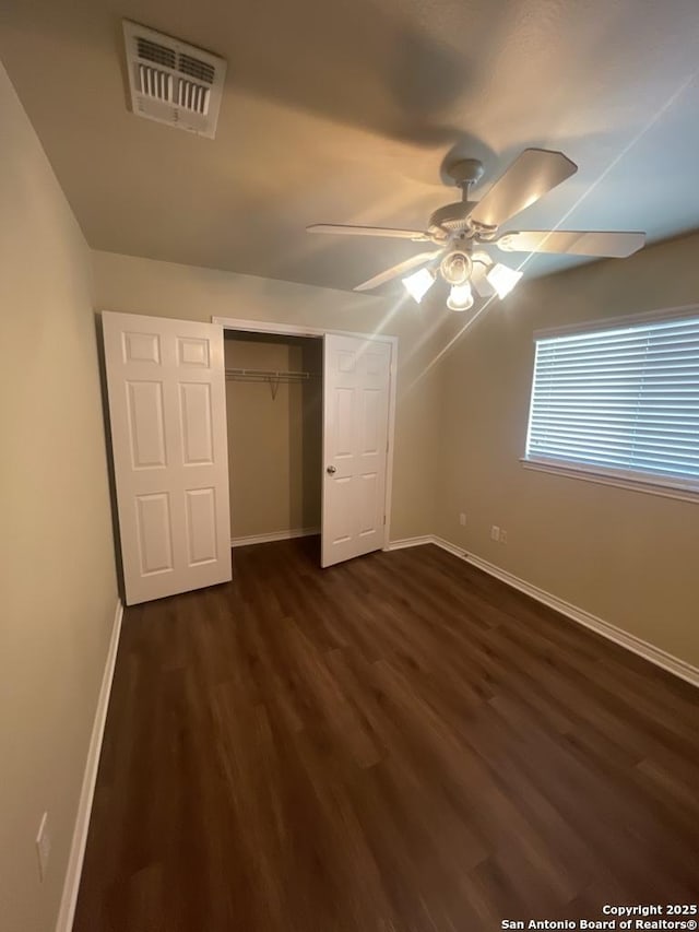 7126 Tourant, San Antonio, TX 78240 - unfurnished bedroom featuring a ceiling fan, a closet, visible vents, dark wood-style flooring, and baseboards