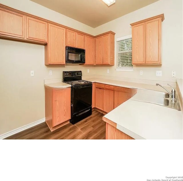 7126 Tourant, San Antonio, TX 78240 - kitchen featuring light countertops, light brown cabinets, black appliances, and dark wood-style floors