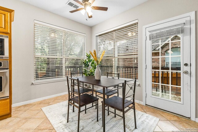 13911 Laurelbrook, San Antonio, TX 78249 - dining room featuring baseboards, ceiling fan, visible vents, and light tile patterned floors