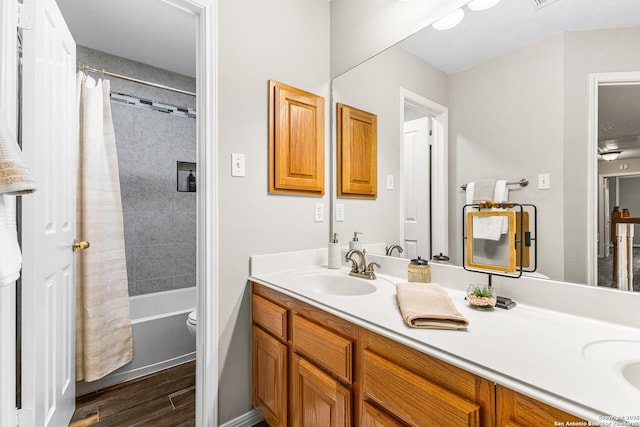 13911 Laurelbrook, San Antonio, TX 78249 - bathroom featuring toilet, a sink, shower / bath combination with curtain, double vanity, and wood finished floors