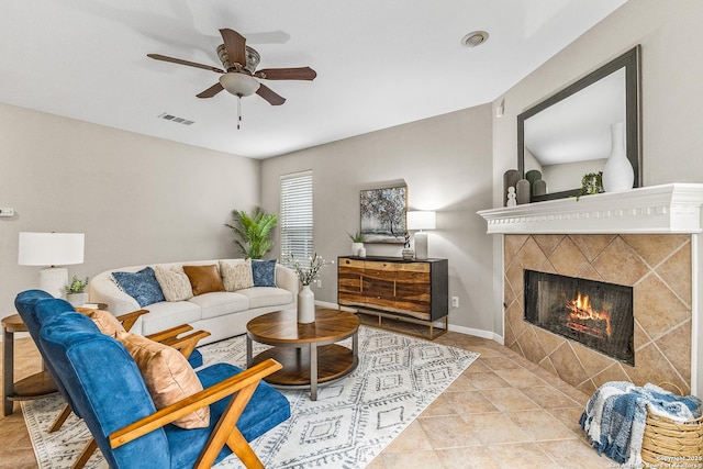 13911 Laurelbrook, San Antonio, TX 78249 - living area with tile patterned flooring, baseboards, ceiling fan, visible vents, and a fireplace