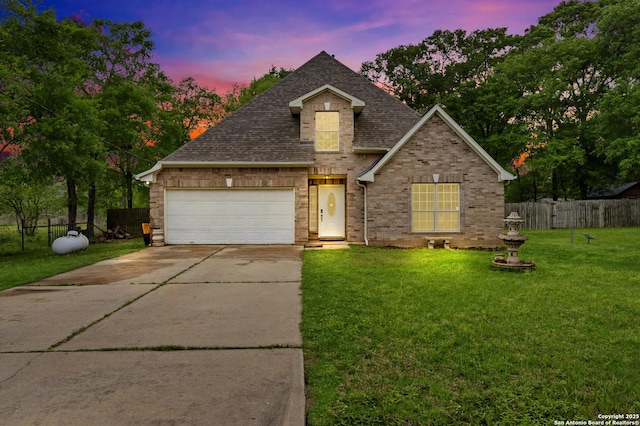 24704 Killarney St, Hempstead, TX 77445 - traditional-style home with driveway, fence, a garage, a shingled roof, and a front yard