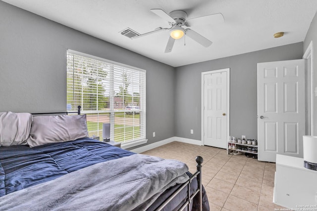 24704 Killarney St, Hempstead, TX 77445 - bedroom with a ceiling fan, baseboards, light tile patterned flooring, and visible vents