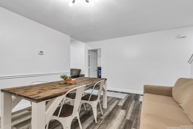 24704 Killarney St, Hempstead, TX 77445 - dining space with baseboards, dark wood-type flooring, and a textured ceiling