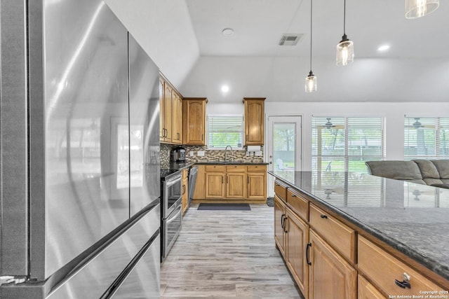 24704 Killarney St, Hempstead, TX 77445 - kitchen with hanging light fixtures, a sink, decorative backsplash, stainless steel appliances, and visible vents