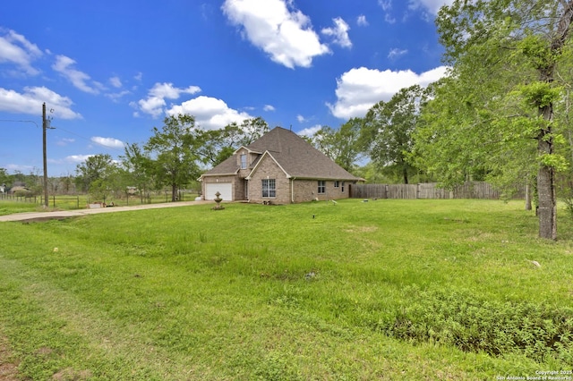 24704 Killarney St, Hempstead, TX 77445 - view of front facade with fence, a shingled roof, concrete driveway, a front yard, and a garage