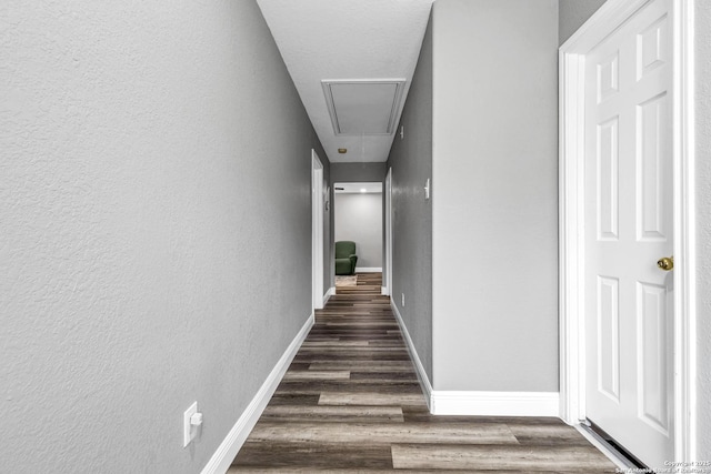 24704 Killarney St, Hempstead, TX 77445 - hallway with attic access, wood finished floors, baseboards, and a textured wall