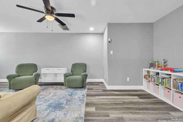 24704 Killarney St, Hempstead, TX 77445 - living area featuring baseboards, wood finished floors, visible vents, and ceiling fan