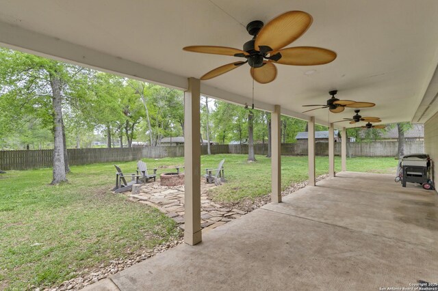 24704 Killarney St, Hempstead, TX 77445 - view of patio / terrace featuring a fenced backyard, an outdoor fire pit, and a ceiling fan