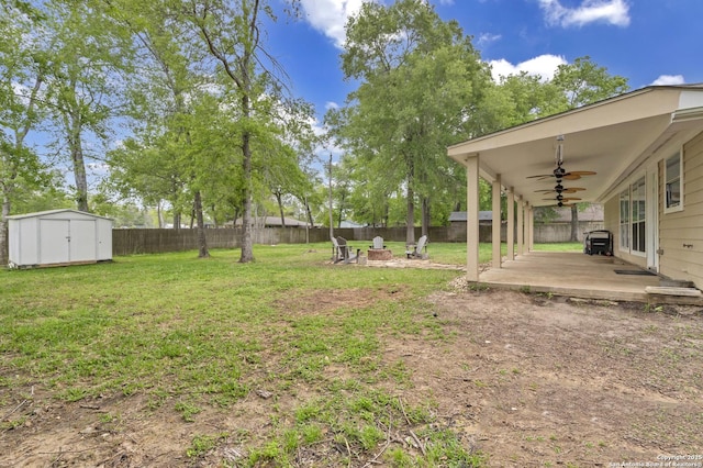 24704 Killarney St, Hempstead, TX 77445 - view of yard with a fenced backyard, a storage shed, ceiling fan, an outdoor structure, and a fire pit