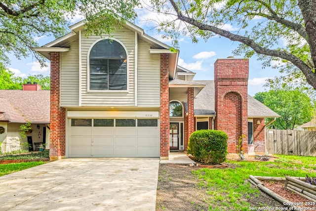 15338 Winter Mist Dr, San Antonio, TX 78247 - view of front of house with an attached garage, a chimney, fence, brick siding, and driveway