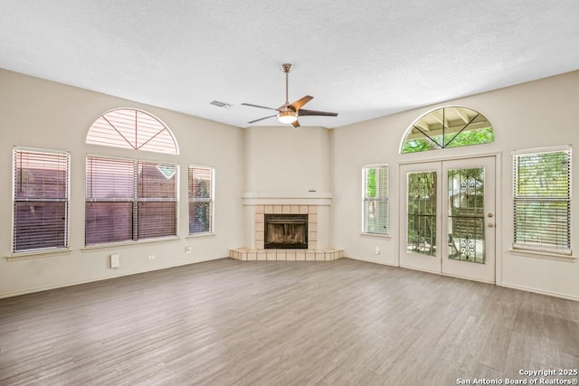 15338 Winter Mist Dr, San Antonio, TX 78247 - unfurnished living room featuring visible vents, a ceiling fan, plenty of natural light, and wood finished floors