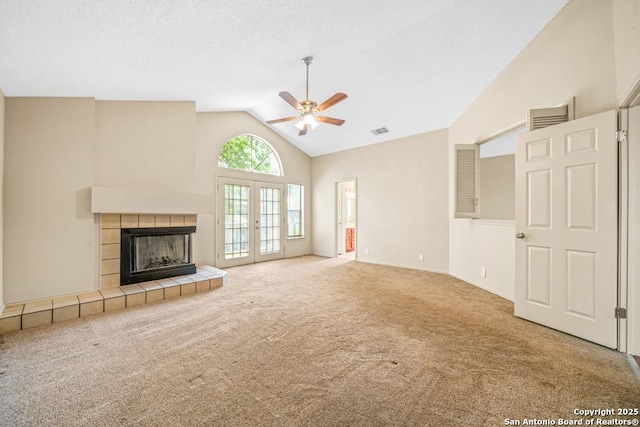 15338 Winter Mist Dr, San Antonio, TX 78247 - unfurnished living room featuring a fireplace, carpet flooring, a ceiling fan, visible vents, and high vaulted ceiling