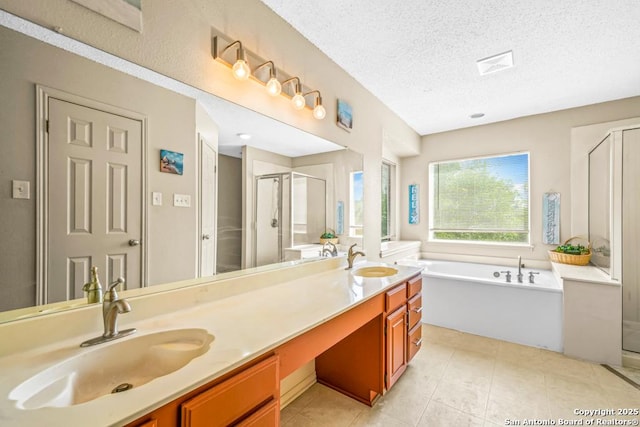 15338 Winter Mist Dr, San Antonio, TX 78247 - full bathroom featuring a sink, a shower stall, a garden tub, and a textured ceiling