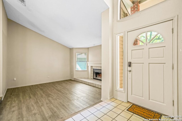 15338 Winter Mist Dr, San Antonio, TX 78247 - foyer entrance featuring a tiled fireplace, visible vents, baseboards, and light wood finished floors