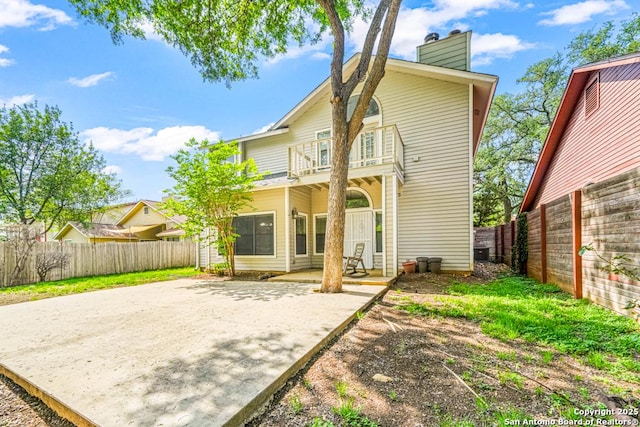 15338 Winter Mist Dr, San Antonio, TX 78247 - rear view of property featuring a chimney, a patio area, a fenced backyard, and a balcony