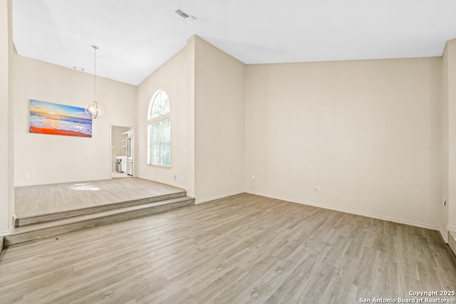 15338 Winter Mist Dr, San Antonio, TX 78247 - empty room with visible vents, baseboards, a notable chandelier, and wood finished floors