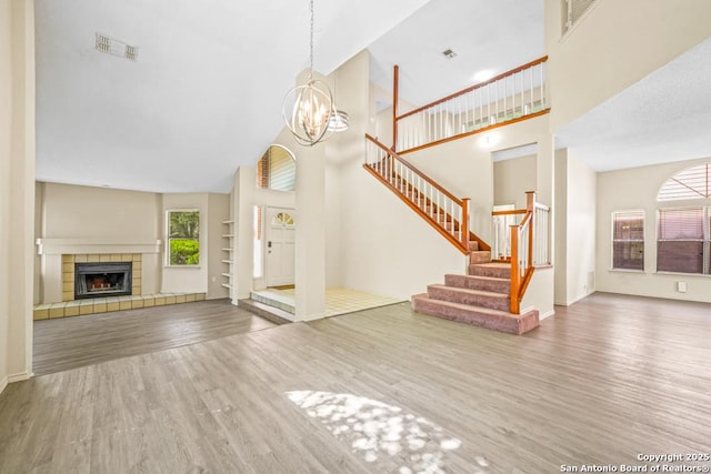 15338 Winter Mist Dr, San Antonio, TX 78247 - unfurnished living room with a healthy amount of sunlight, wood finished floors, visible vents, and high vaulted ceiling