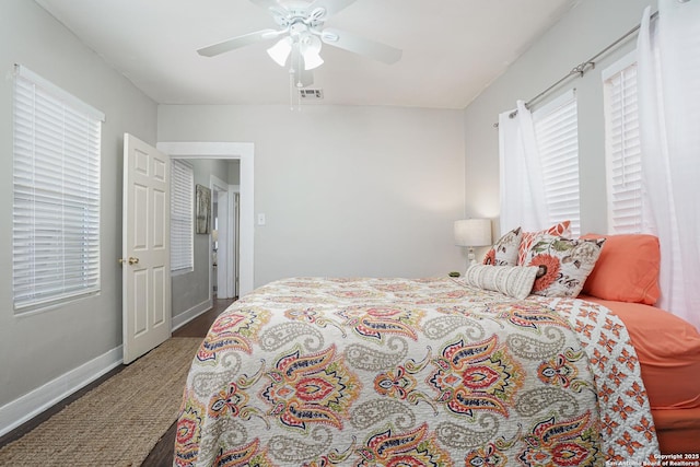 bedroom featuring baseboards, a ceiling fan, and visible vents