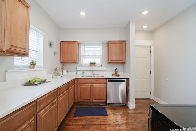 kitchen featuring dark wood-style flooring, recessed lighting, light countertops, stainless steel dishwasher, and a sink