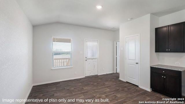 1506 Champagne Oak, New Braunfels, TX 78130 - interior space with baseboards, dark wood finished floors, and vaulted ceiling