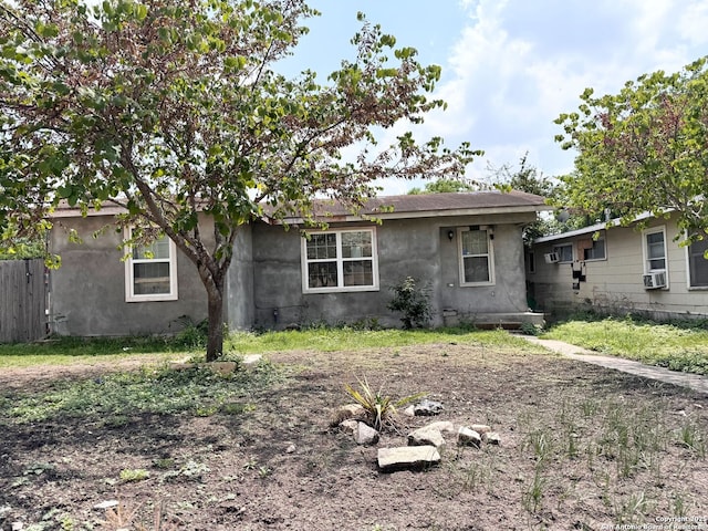 934 Iowa, San Antonio, TX 78203 - view of front facade with cooling unit, stucco siding, and fence