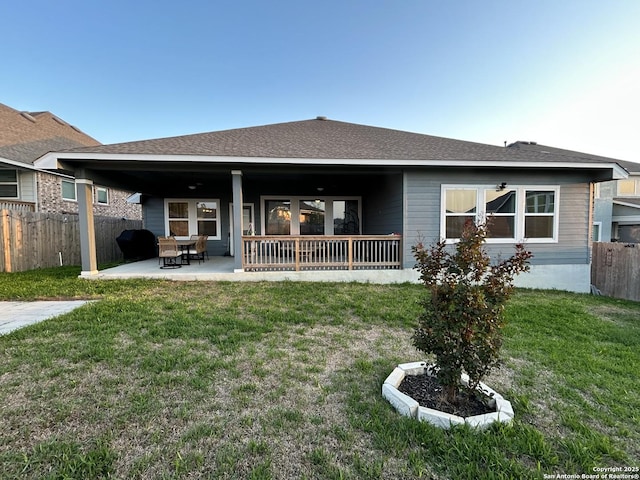 12835 Fort Belknap, San Antonio, TX 78245 - back of property featuring a patio, fence, and a lawn