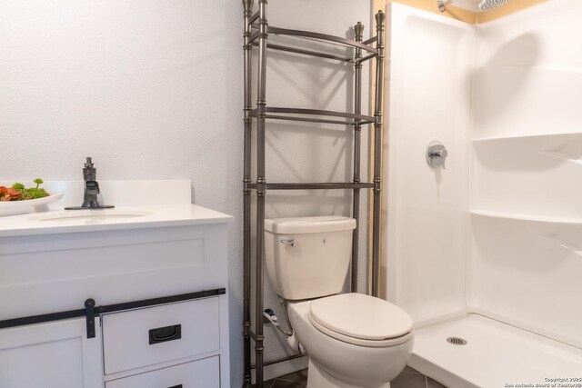 4935 Driskill St, San Antonio, TX 78228 - full bath with a shower stall, vanity, a textured wall, and toilet