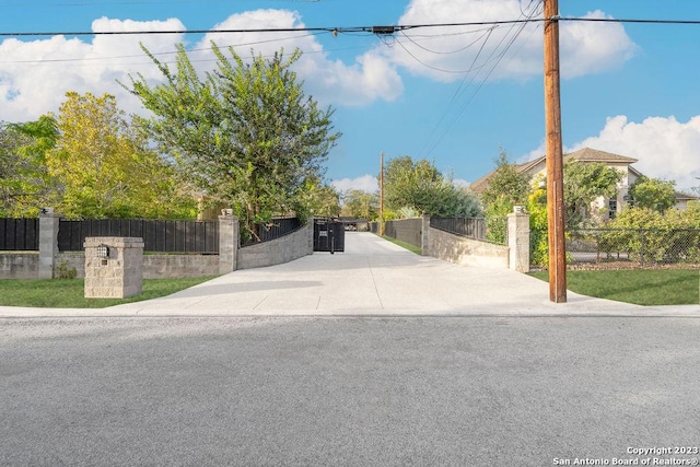 4935 Driskill St, San Antonio, TX 78228 - view of road with a gate and concrete driveway