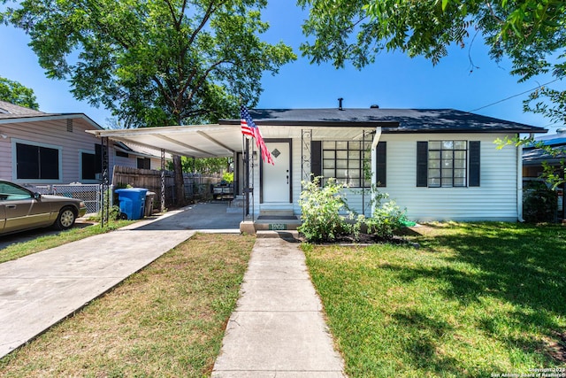 1209 Kentucky Ave, San Antonio, TX 78201 - view of front of property with a carport, driveway, fence, and a front lawn