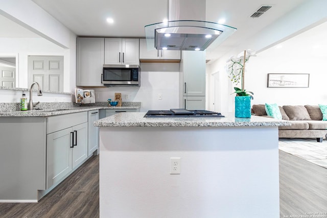 1209 Kentucky Ave, San Antonio, TX 78201 - kitchen with island exhaust hood, light stone countertops, visible vents, stainless steel appliances, and a sink