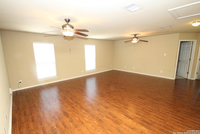 empty room with visible vents, baseboards, a ceiling fan, and wood finished floors