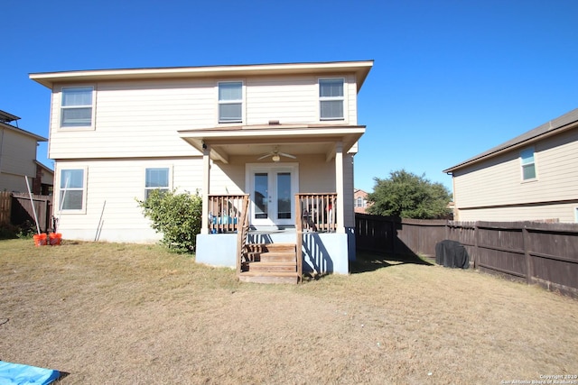 view of front of house with a front yard, french doors, a fenced backyard, and ceiling fan