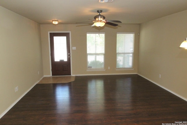 entrance foyer with visible vents, ceiling fan, wood finished floors, and baseboards